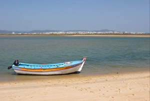Algarve Prints: View of city from coastal island with fishing boat, Figo, Algarve, Portugal, april