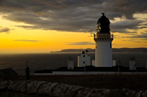 Clifftops Prints: View of clifftop lighthouse at sunset