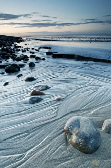 Pebbles Prints: View of coastal mudflats with channels and pebbles at twilight