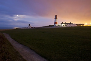 Sun Set Prints: View of coastline and lighthouse at sunset