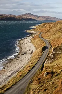 Peak Prints: View of coastline with only road on island, leading in direction of Feolin