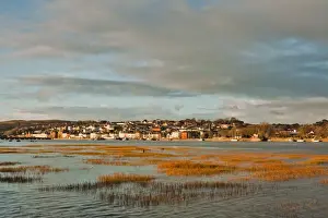 Skies Prints: View across estuary with receeding tide towards town on sunny winter morning
