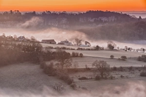 Sunrise Prints: View of farmland and river shrouded in mist at sunrise