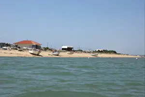 Algarve Prints: View of fishing village with fishermens houses on landward side of coastal spit