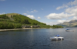 View of freshwater loch with boats, near Luss, Loch Lomand, Argyll and Bute, Scotland, may