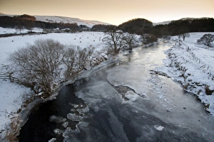 Wintery Prints: View of frozen river and snow covered pasture with sheep