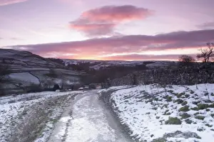 Gates Prints: View of gate, drystone walls, footpath and surrounding hillside in snow at sunrise