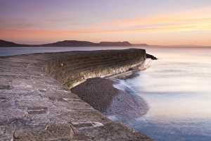 Town Prints: View of harbour wall at low tide during sunrise