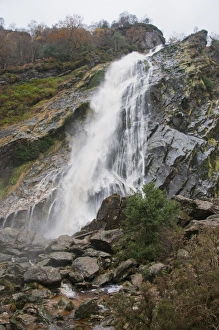 County Prints: View of horsetail waterfall flowing over rocks
