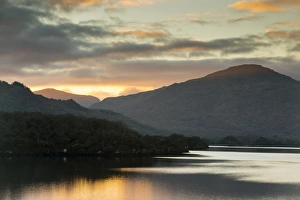 : View of lake and mountains at sunset