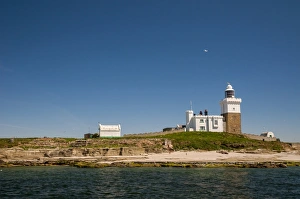 Shore Prints: View of lighthouse and beach on island