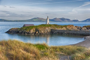 View of lighthouse and coastline on tidal island, Llanddwyn Island, Newborough Warren National Nature Reserve