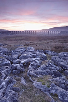 L Imestone Prints: View of limestone rocks and Ribblehead Viaduct at sunset