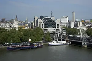 View from London Eye of city river with boats and Charing Cross railway station, Hungerford Bridge, River Thames