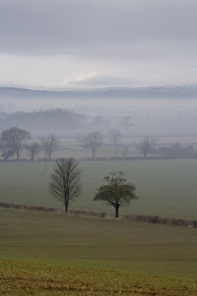 Moor Land Prints: View of mist over fields, with low cloud over moorland in distance