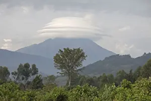 Equatorial Prints: View of montane landscape and distant volcano with lenticular cloud formation