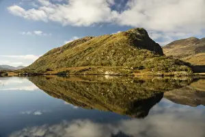 : View of mountain reflected in narrow channel connecting lakes