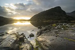 View of mountain reflected in narrow channel connecting lakes at sunset, The Long Range, Lakes of Killarney