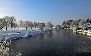River Bank Prints: View of partially frozen river and snow covered riverbanks