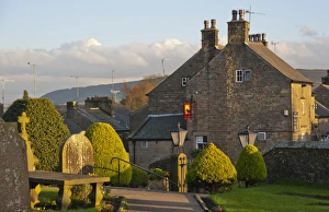 Grave Yard Prints: View of pub and village from churchyard in evening sunlight