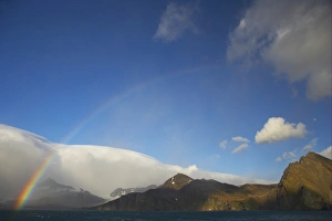 Moon Prints: View of rainbow and moon over coastline, St. Andrews Bay, South Georgia