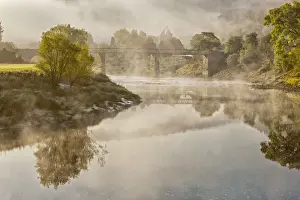 Ruined Prints: View of river, bridge and Cistercian abbey ruins in mist at dawn