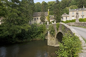 : View of river and old bridge near manor house