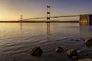 View of road bridge over river at sunset, viewed from Aust, Severn Bridge (First Severn Crossing), River Severn