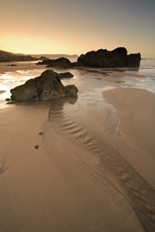 Sandy Prints: View of rocks on sandy beach at low tide, at sunrise, Whitsand Bay, Cornwall, England
