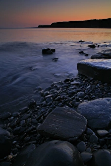 Shore Lines Prints: View of rocky beach with afterglow at sunset