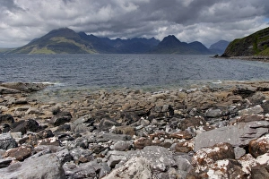 Peak Prints: View from rocky beach across sea loch towards
