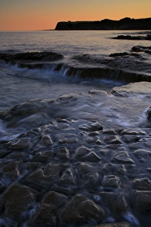 Mood Prints: View of rocky beach at sunset, Hobarrow Bay, Isle of Purbeck, Dorset, England, july
