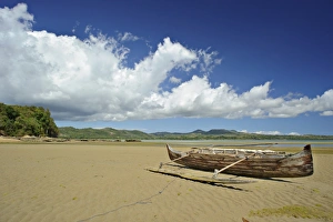 Canoe Prints: View of sandy beach with small boat, Nosy Be, Madagascar