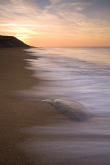 View of sandy beach at sunrise, Burton Bradstock, Dorset, England, february