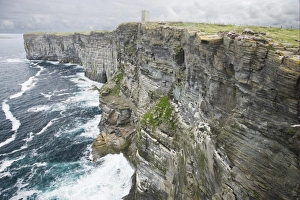 Orkney Prints: View of sea cliffs with Kitchener memorial tower on clifftop