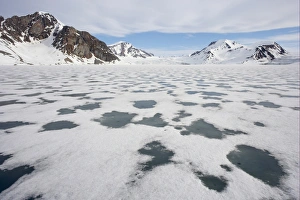 View of sea ice and snow covered coastal mountains, Spitsbergen, Svalbard, late spring