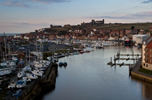 Town Prints: View of seaside town with boats moored on river at dusk, with St. Marys Church