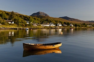 Peak Prints: View of small wooden boat and village houses in bay