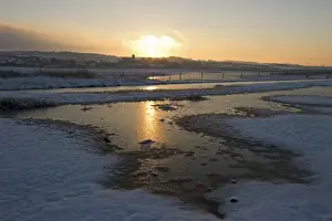 Wintery Prints: View of snow covered coastal grazing marsh habitat at sunset