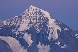 Peak Prints: View of snow covered mountain peak at dusk