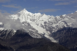 Peak Prints: View of snow covered mountain peak and glacier at dawn