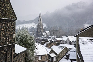 Religions Prints: View across snow covered rooftops towards church spire in town