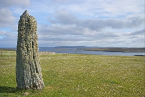 Stones Prints: View of standing stone and coastline, Clivocast, Unst, Shetland Islands, Scotland, June