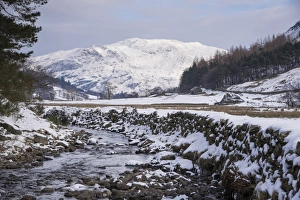 Wintery Prints: View of stream flowing through snow covered upland landscape