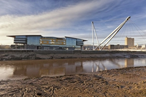 Landmarks Prints: View of tidal river, waterfront buildings and footbridge