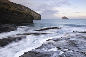 Wave Prints: View of tide rushing in over coastal rocks at sunrise