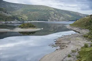 Reservoirs Prints: View of upland reservoir with low water level and remains of submerged village exposed after dry summer