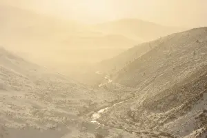 Caledonian Prints: View of upland river valley with Spindrift of fine snow blown off by wind at sunset