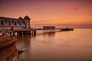 Trending: View of Victorian pier in seaside town at sunrise