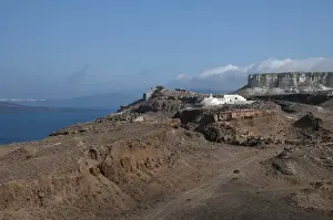 Santorini Prints: View of volcanic coastal landscape with white-washed Orthodox church